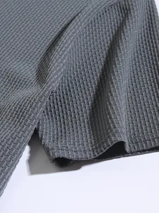 Macro view of the breathable waffle texture on gray men's stretch sports polo shirt