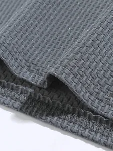 Close-up detail of the breathable textured fabric on this men's athletic polo shirt.