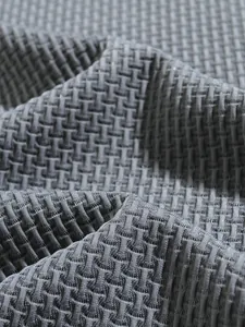 Macro detail showing the breathable grey waffle knit texture of a men's polo shirt