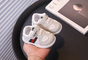 Comfortable white baby toddler sneakers featuring soft anti-slip soles and iconic striped detail