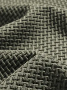 Close-up macro detail of olive green 3D weave texture fabric for men's polo shirt