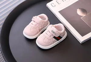 Detailed view of pink baby walking shoes with quilted design and soft soles