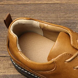 Close-up of the comfortable padded heel and lining inside a men's brown leather business shoe.