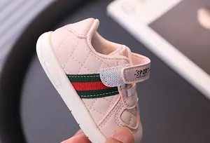 Close-up view of pink baby walking sneakers with soft non-slip soles for toddlers
