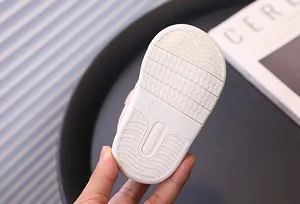 Detailed view of the anti-slip soft rubber sole on these pink baby walking sneakers