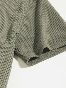 Close-up detail of olive green textured knit fabric on a men's polo shirt sleeve