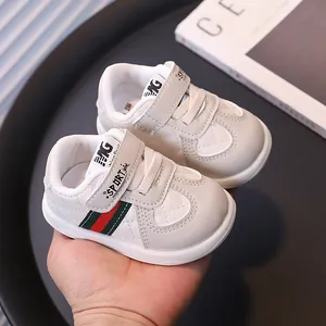 Stylish white baby walking shoes with soft non-slip soles and decorative stripes