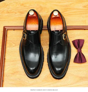 Top-down view of black cowhide derby shoes with monk strap buckle and thick sole detail.