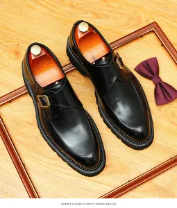 Top view of black leather monk strap shoes with thick soles and metal buckle.