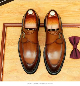 Top-down view of premium brown leather monk strap shoes with vintage wooden props