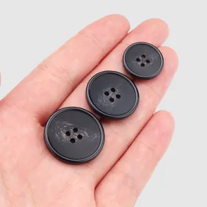 Set of three high-quality black resin buttons in different sizes for clothing accessories