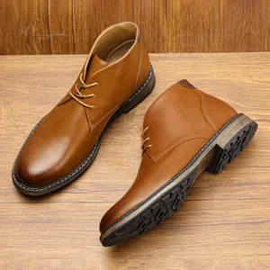 Close-up of classic brown leather men's chukka boots on wood background