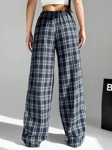 Rear view of women's stylish black and white plaid wide-leg trousers in casual style