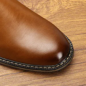 Detailed macro view of premium brown leather boot toe featuring durable welt stitching