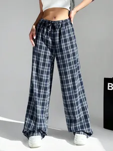 Detailed view of women's plaid wide-leg trousers in a casual street style look.