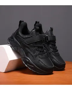 Detailed view of black children's athletic sneakers with a durable chunky sole