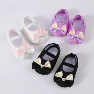 Assorted soft sole baby princess shoes in white, purple and black with heart bows