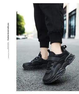 Black breathable mesh children's sneakers with chunky soles and hook-and-loop strap.