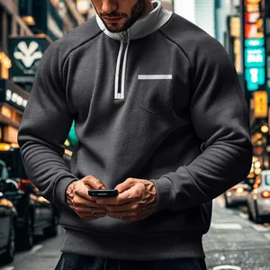 Detailaufnahme eines grauen Herren-Sweatshirts mit halbem Reißverschluss und Stehkragen.