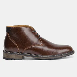 Side profile detail of classic men's brown leather chukka desert boots with laces.