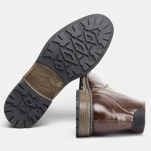 Detail view of men's retro brown leather boots showing non-slip sole and side stitching