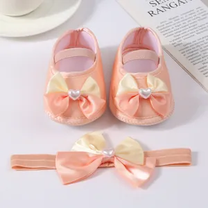 Peach satin baby princess shoes and matching bow headband set for newborns