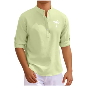Detailed close-up of light green waffle textured men's shirt with white palm tree print