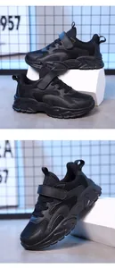 Detail of black breathable mesh kids sports sneakers with velcro strap