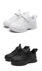 Classic children's sports shoes shown in white and black with hook and loop straps
