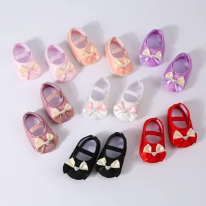 Assorted colors of soft-sole baby princess shoes featuring bows and heart pearls