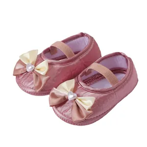 Pink satin baby princess shoes with cream bow and heart pearl detail for newborns