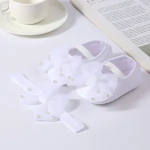 Elegant white baby girl shoes and headband set with decorative lace bows and pearl accents