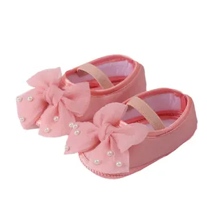 Elegant pink baby Mary Jane shoes featuring large mesh bows and delicate pearl accents