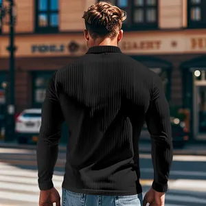 Back view showing the fit and texture of a black ribbed long sleeve polo shirt for men outdoors