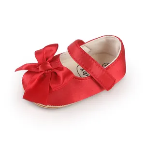 Red baby walking shoes with a large decorative satin bow for 0-1 year old infants