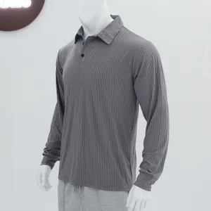Close-up of the grey ribbed knit fabric and lapel design on a men's long-sleeve polo