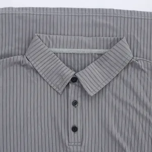 Macro detail view of men's casual gray ribbed polo shirt collar with black buttons