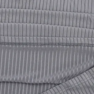 Macro detail of grey vertical ribbed fabric with precise stitching on a men's polo shirt