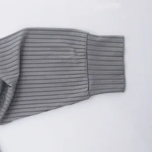 Detail view of the grey ribbed knit cuff on a men's long-sleeve shirt