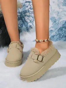 Close-up detail of khaki suede platform snow boots with warm faux fur lining and buckle