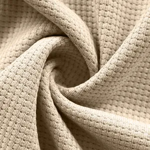 Detail macro shot of high-quality beige waffle knit fabric for casual men's shirts