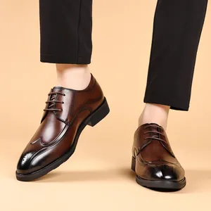 Elegant brown genuine leather brogue dress shoes for men with retro carved detailing.