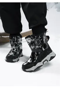 Detail view of warm waterproof children's snow boots with black and white abstract pattern.