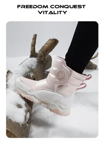 Durable pink and white winter children's snow boots shown on a snowy log detail view