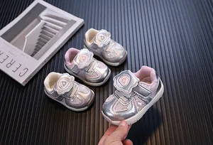 Detail view of stylish pink and silver toddler sneakers with soft EVA soles and Velcro straps