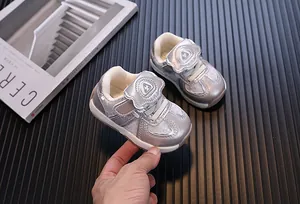 Detailed view of silver toddler sneakers with soft EVA soles and velcro closure.