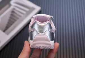 Close-up back view of pink toddler girls sneakers with metallic silver heel accents
