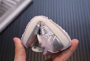 Detail view of the extremely flexible soft sole on these pink and silver baby sneakers