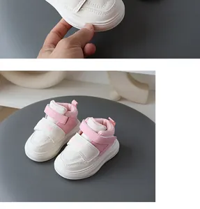 Detail of pink and white toddler sneakers with convenient double velcro straps