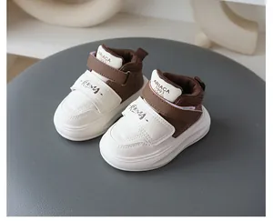 Stylish brown and white toddler sneakers with Velcro straps and soft non-slip soles.